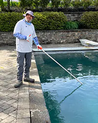 Picture of Hammerhead Pools working on pool equipment