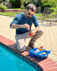 Picture of Hammerhead Pools working on pool equipment